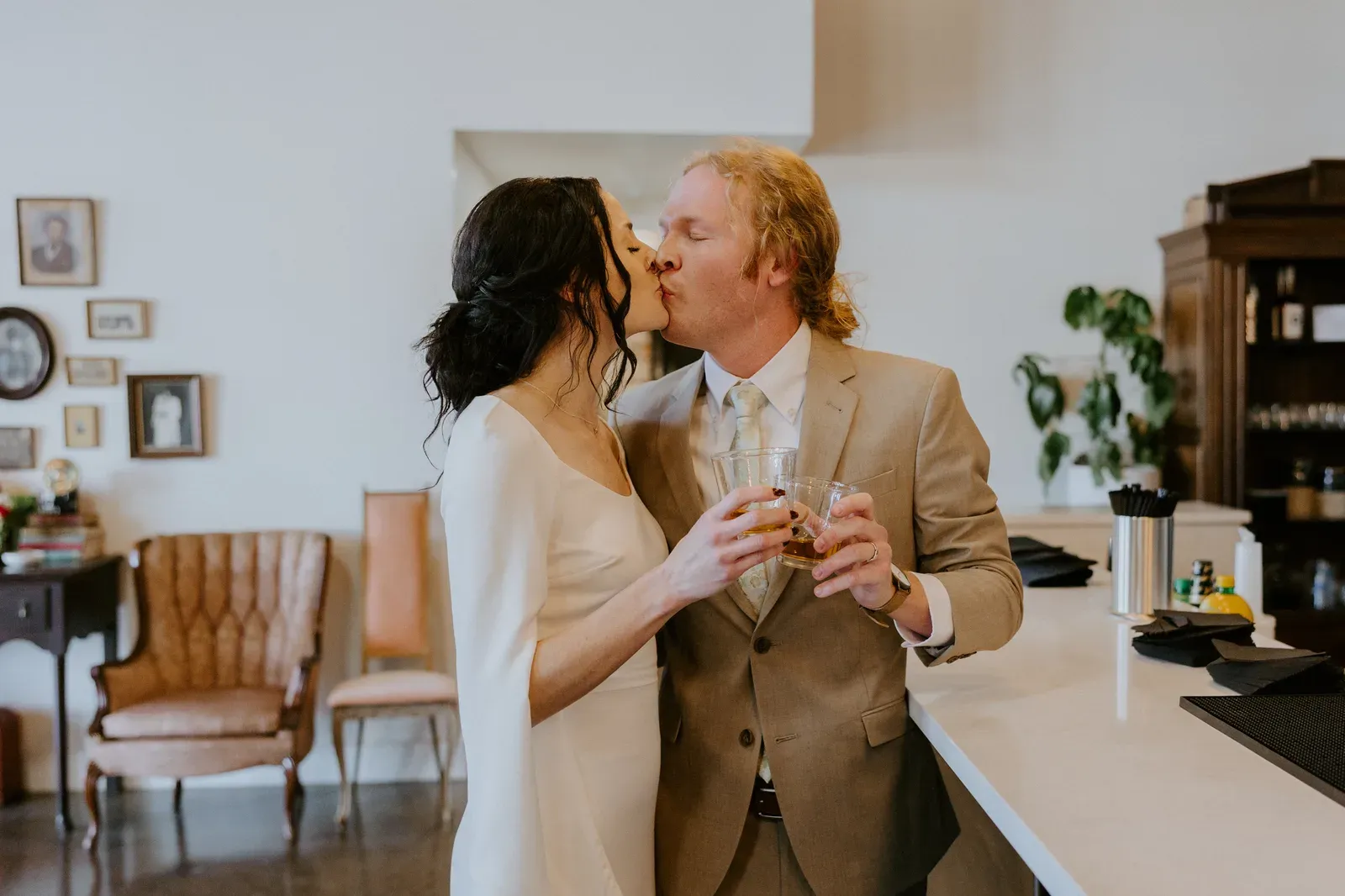 Bartenders mixing cocktails at the 24 Shelby in-house bar with exposed brick and Edison string lights, included in the venue plus services Indianapolis wedding package tier