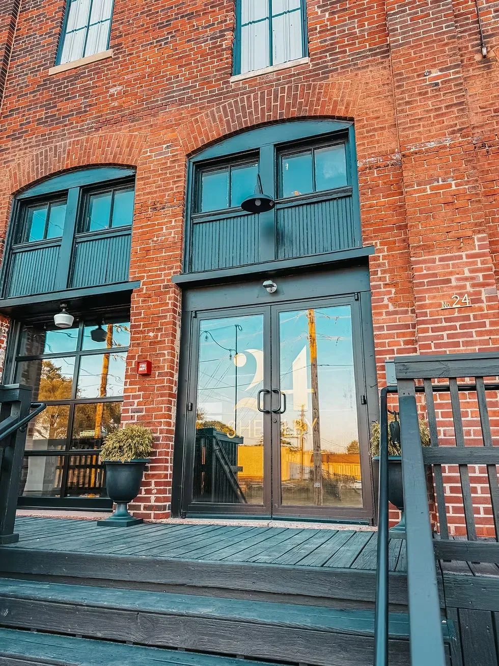 Exterior of 24 Shelby wedding venue in downtown Indianapolis showing the original 1898 brick bottling-house facade and 24 Shelby Bottling Company sign