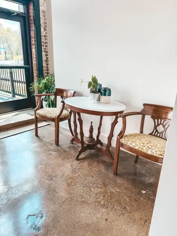 Antique wooden chairs and tables included in a downtown Indianapolis wedding venue rental, the kind of furniture that becomes a hidden cost at blank-canvas venues.