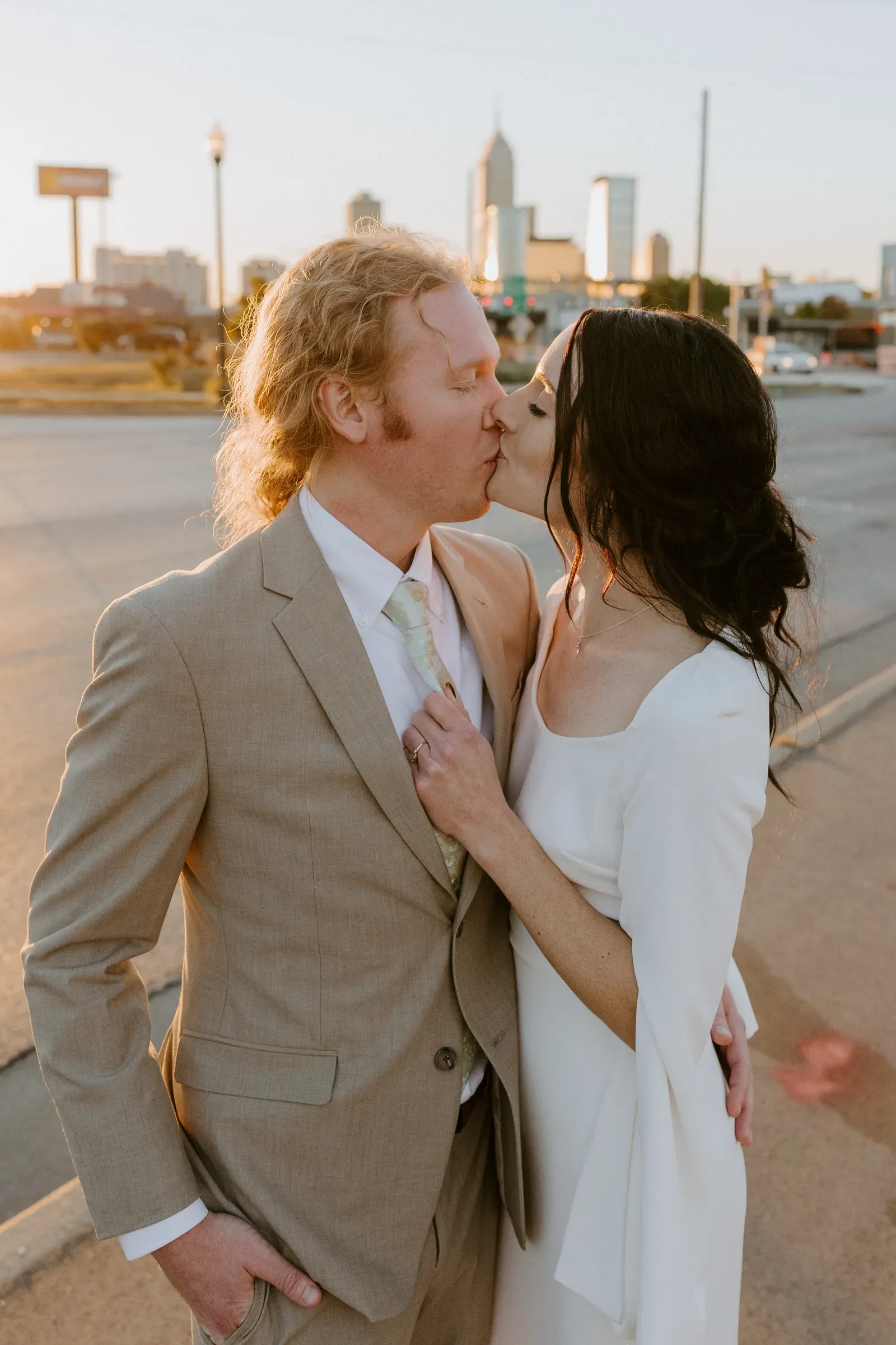 Bride and groom at golden hour with the Indianapolis skyline behind, the kind of sunset shot that drives outdoor wedding venue demand in central Indiana.
