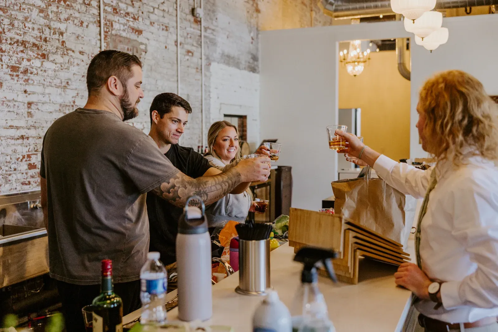Wedding party toasting in the Libations Lounge bar at 24 Shelby during a rehearsal dinner in downtown Indianapolis