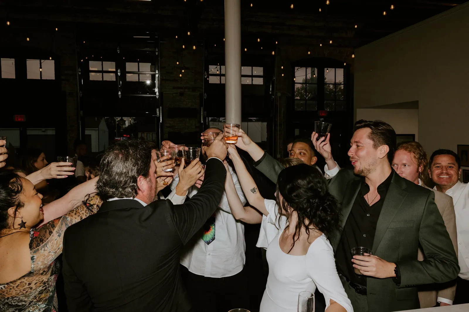 A party under warm string lights at 24 Shelby, a downtown Indianapolis party venue set for an evening celebration