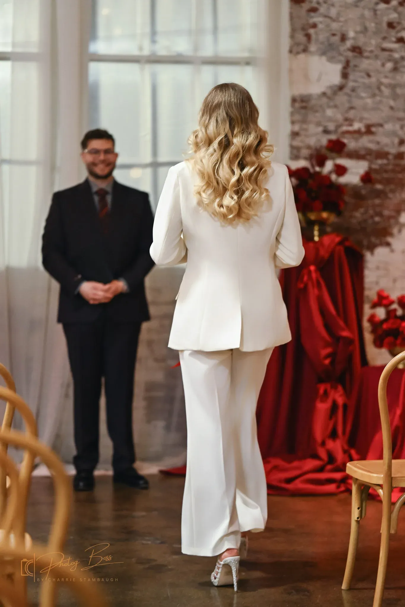 Bride in a white pantsuit walking down the aisle with her groom at a 24 Shelby Indianapolis wedding ceremony, illustrating the 2026 Gen Z trend of personalized non-traditional wedding fashion