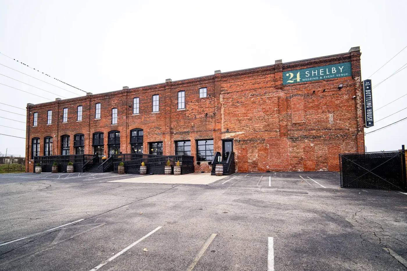 The 1898 brick exterior and parking lot at 24 Shelby in downtown Indianapolis, the load-in approach an outside caterer uses at this wedding venue.