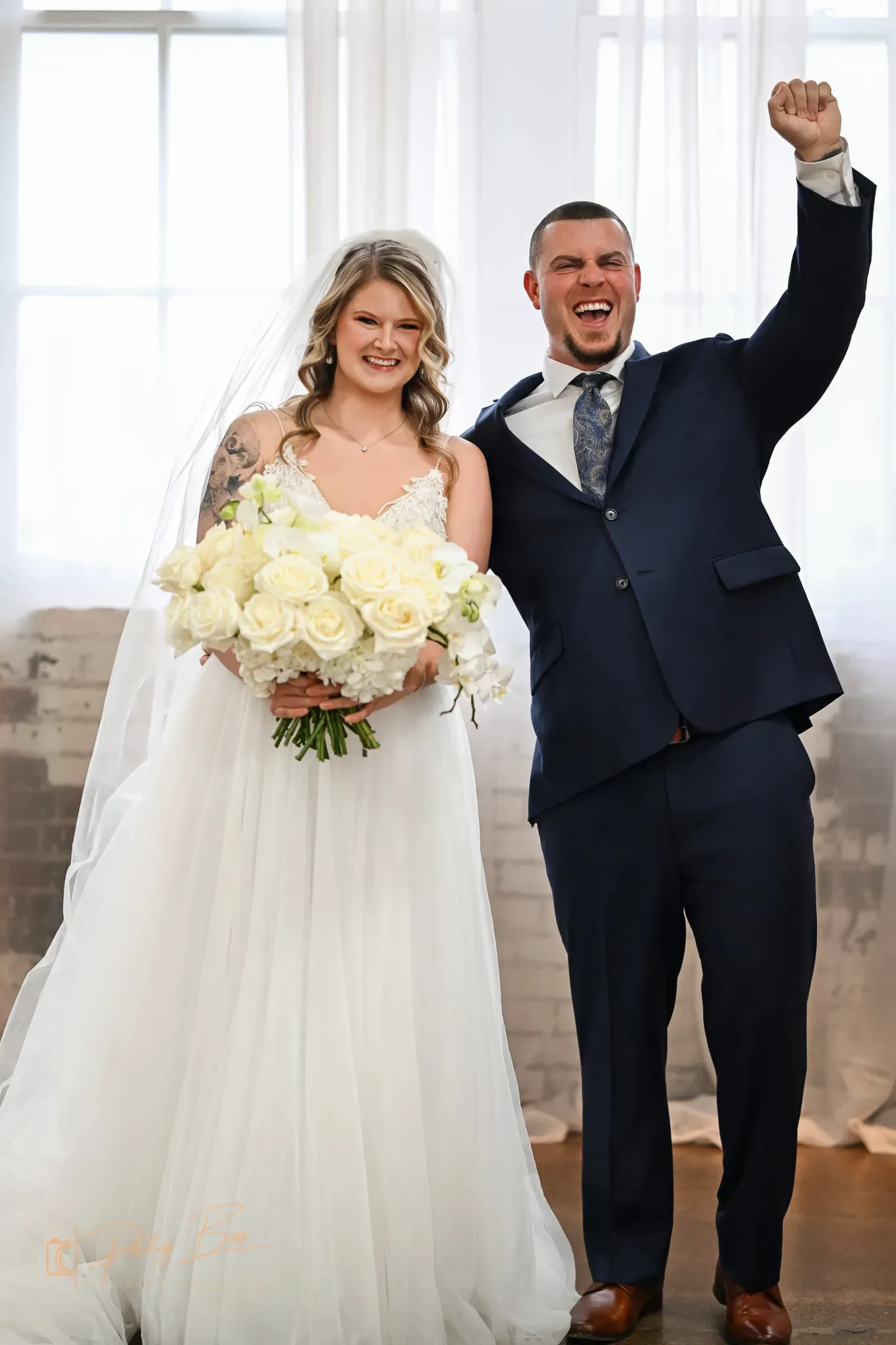 Wedding ceremony at 24 Shelby with guests seated along the original 1898 brick walls under Edison string lights, included in the all-inclusive wedding package