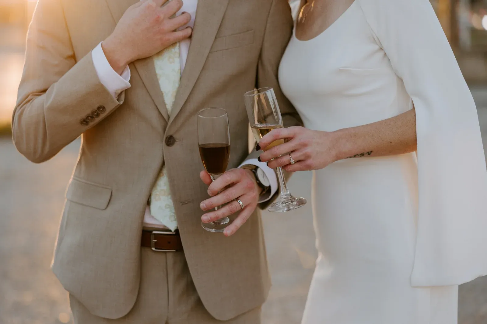 Champagne toast at an intimate Indianapolis micro wedding inside 24 Shelby, with a small group of guests raising glasses against original 1898 brick walls and warm Edison string lights