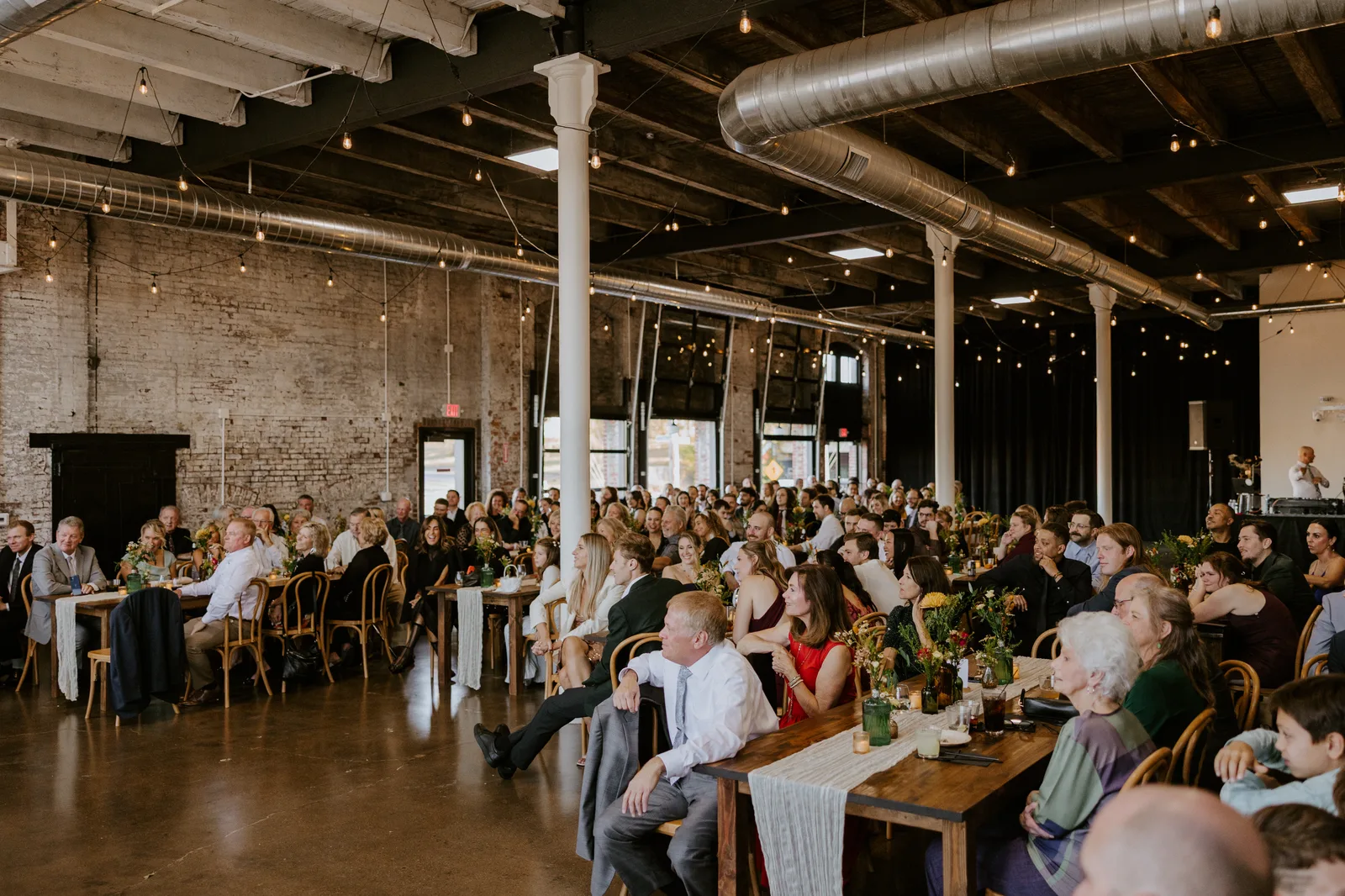 24 Shelby venue interior set for a corporate reception with tables and ambient lighting